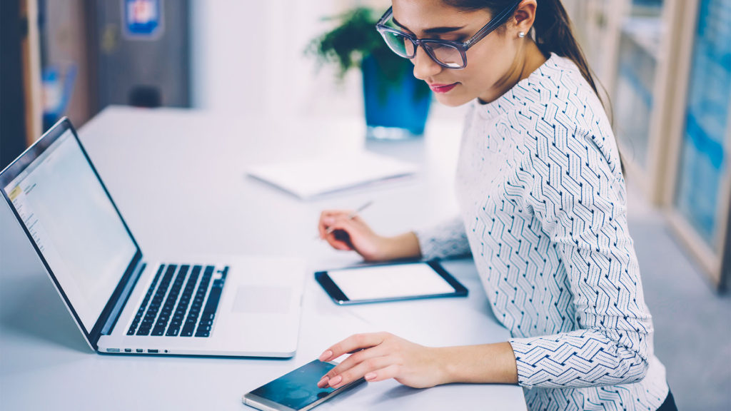 Segurança zero trust mulher em escritório com diversos dispositivos